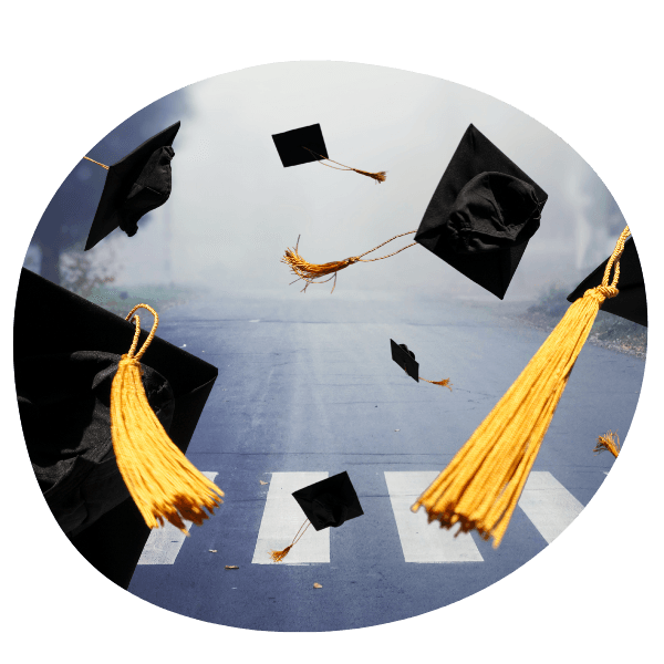 Graduation Caps flying through the air over a crosswalk on a road